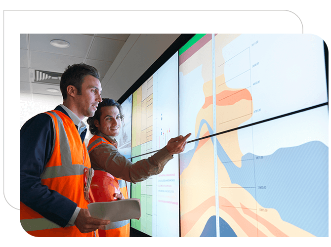 Two male oil gas engineers looking a  terrain map