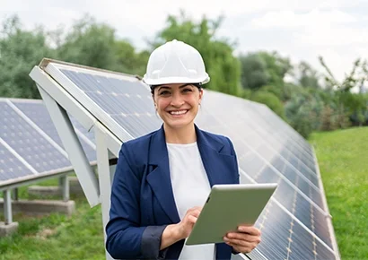 A lady smiling and standing on solar power plant
