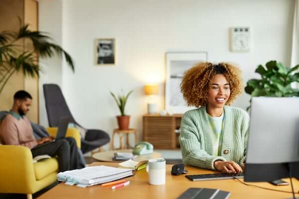 A woman and a man are working at home.