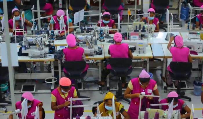 Multiple employees working in a garment factory.
