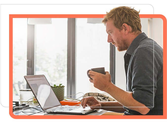 Man working in laptop and having coffee with another hand.