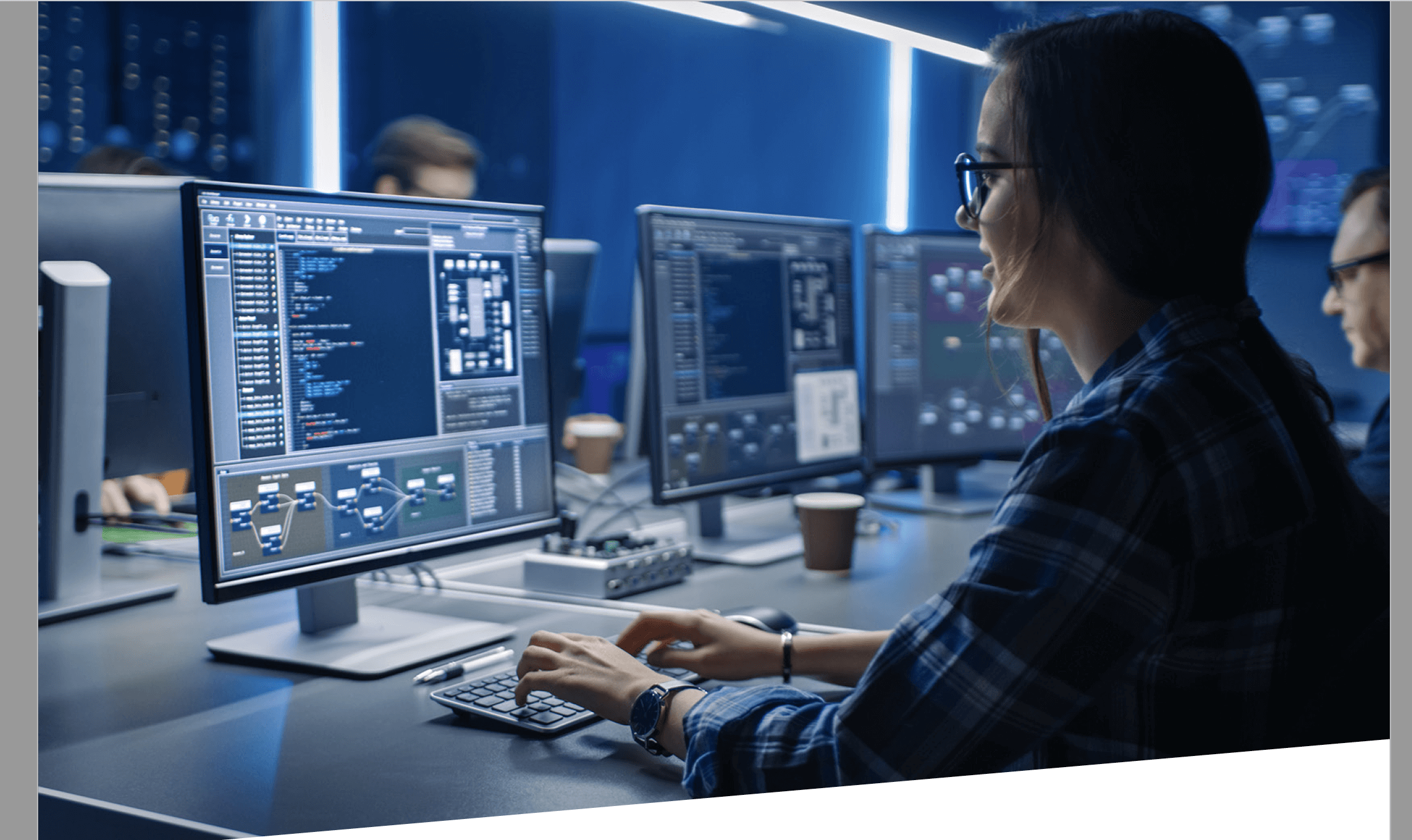 Woman with glasses in blue data center on computer