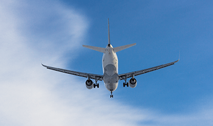 Airplane flying high in blue sky