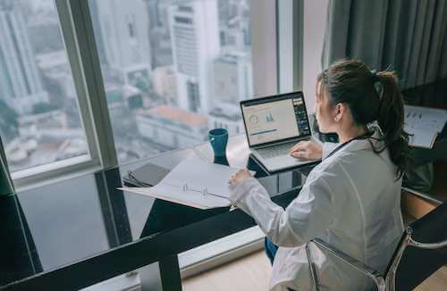 A women is Working in the laptop about health care information.