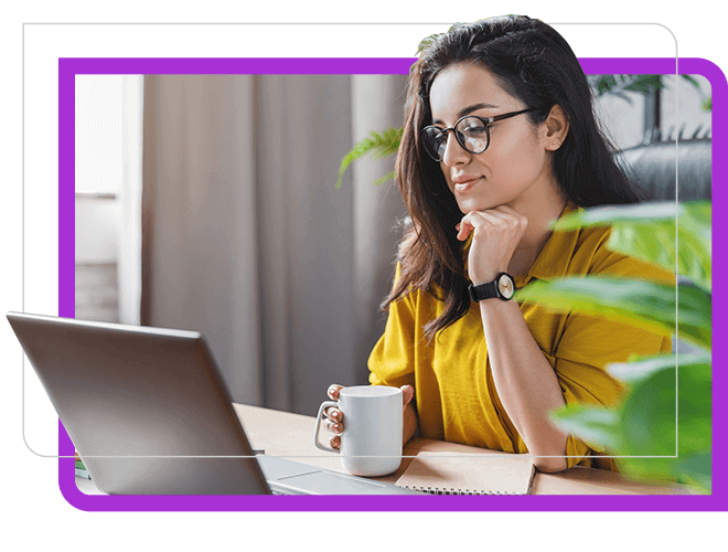 Young woman with coffee cup, yellow top looking at laptop thinking.