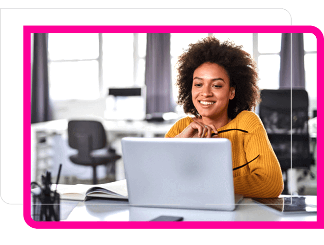 Young African woman in yellow sweater holding eye glasses leoking at laptop