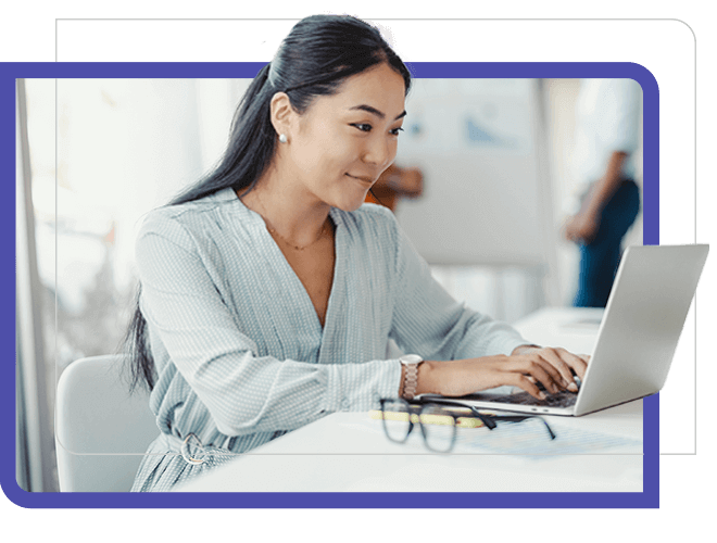 smiling woman looking at laptop with white background