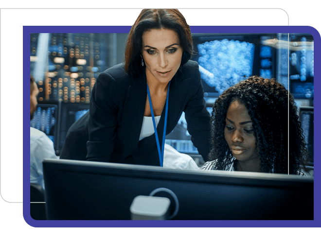 security compliance, two women in dark computer room looking at screens