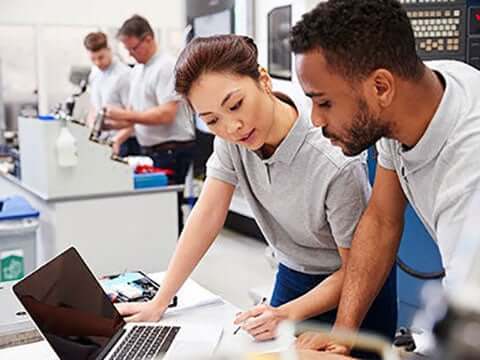 Two IT staff working better together on a project in the office