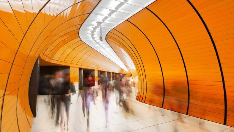 blurred look of orange tunnel people walking