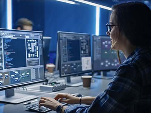 woman working n a secure dark data center.