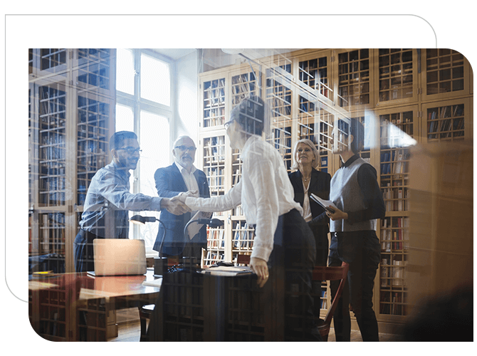 Group law firm associates shaking hands in bright office setting