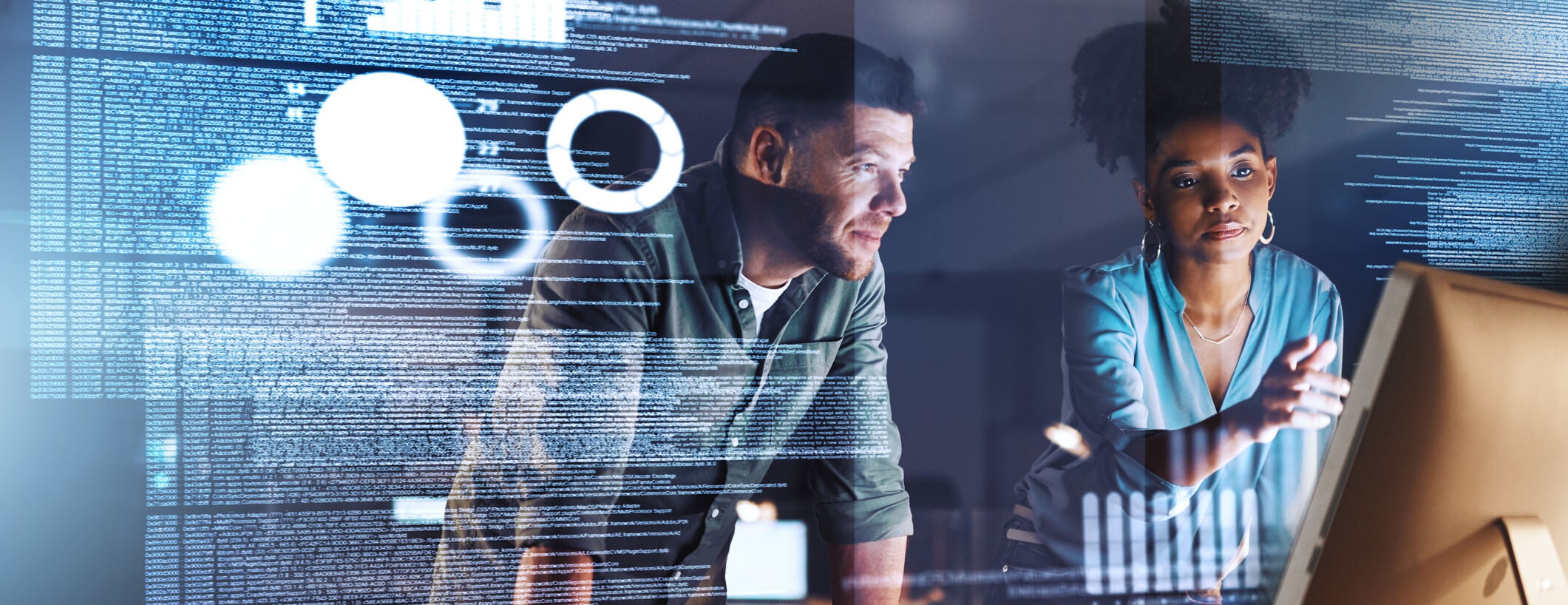 Shot of two programmers working together on a computer code at night