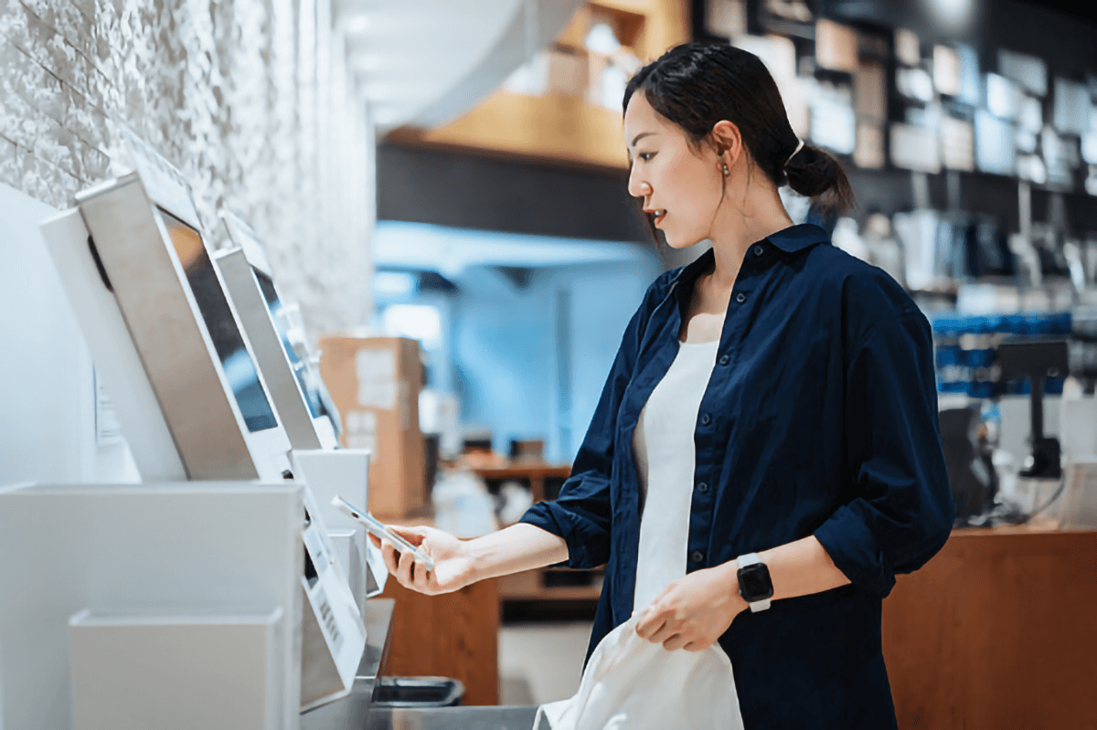 Lady paying bill using scanner