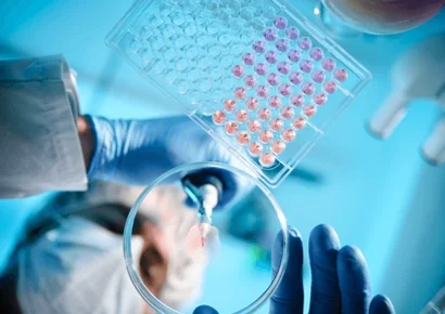 Lab: A scientist using a pipette with a microtiter plate and a petri dish