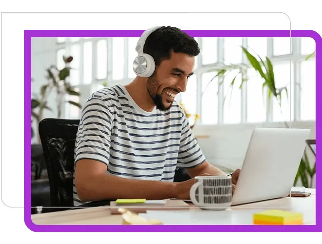 An Engineer wearing headphone is talking to team member in laptop.