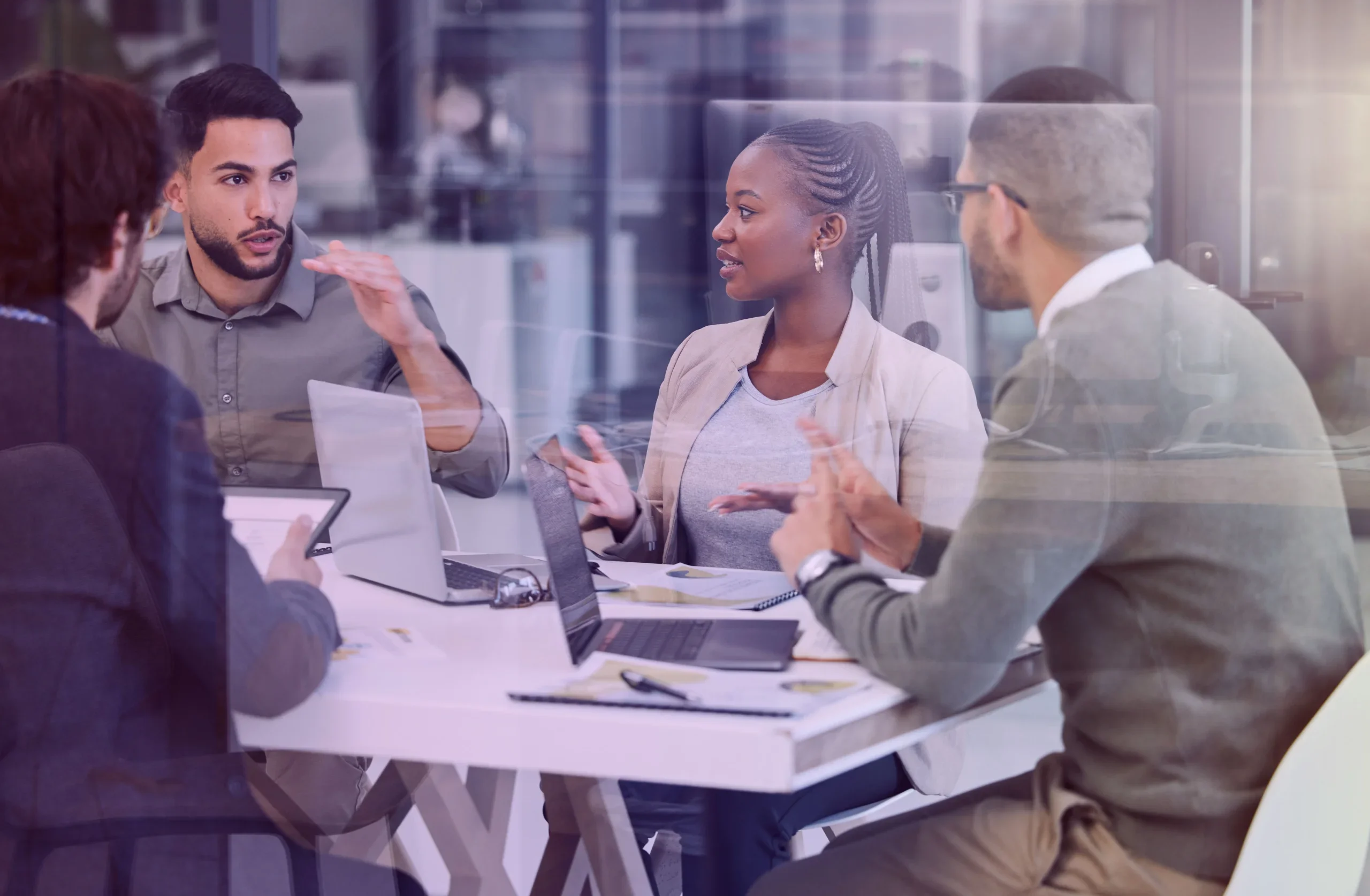 small group is gathered around a table in meeting room