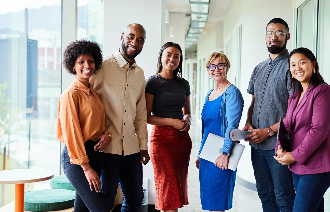 standing group of diverse co-worker in office in bright color clothes